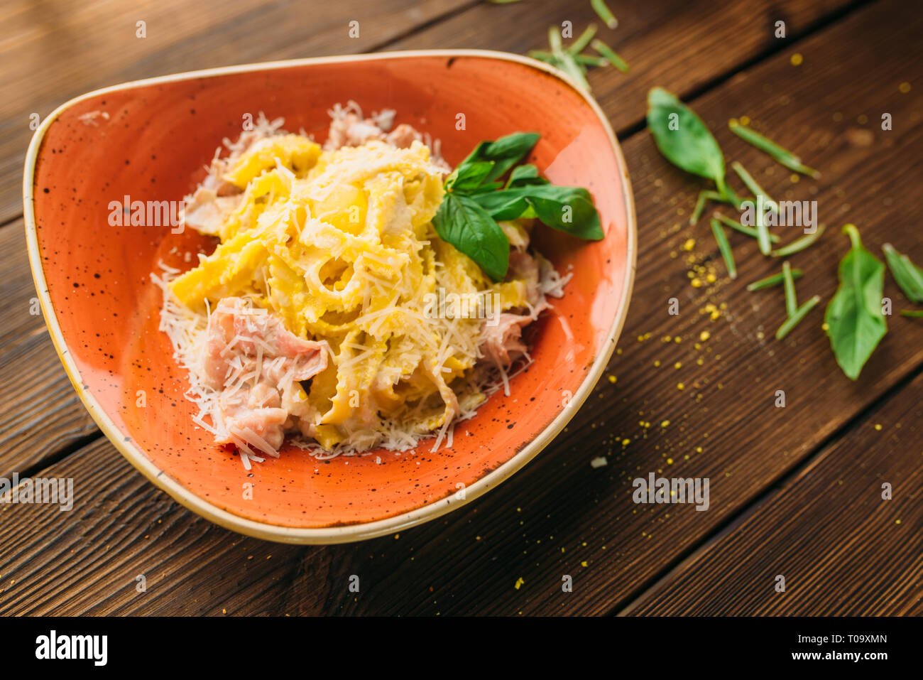 Pasta and meat in a bowl on wooden table closeup, nobody. Second dish, food preparation, cooking Stock Photo