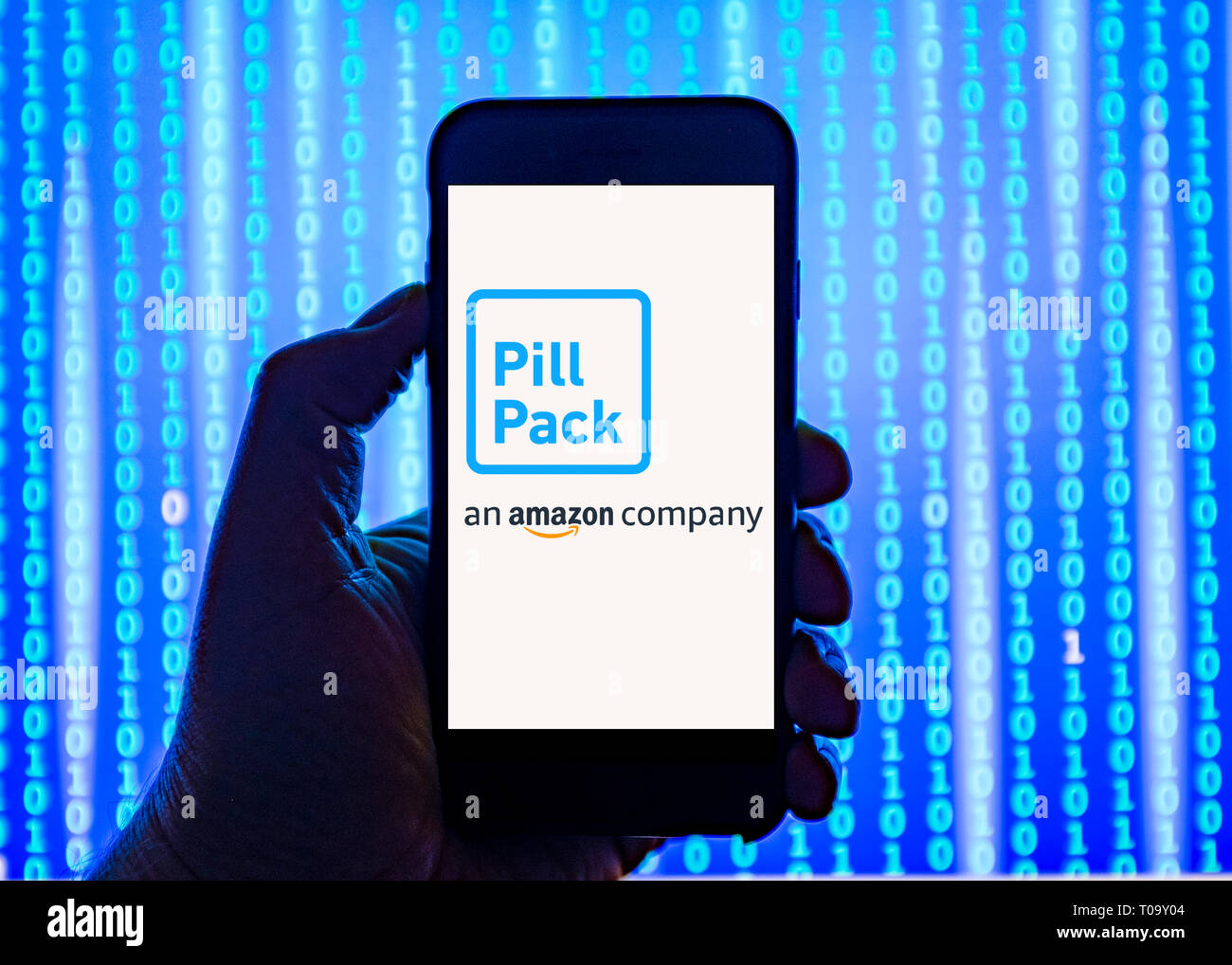 Person holding smart phone with  amazon Pill-Pack online pharmacy website  logo displayed on the screen. Stock Photo