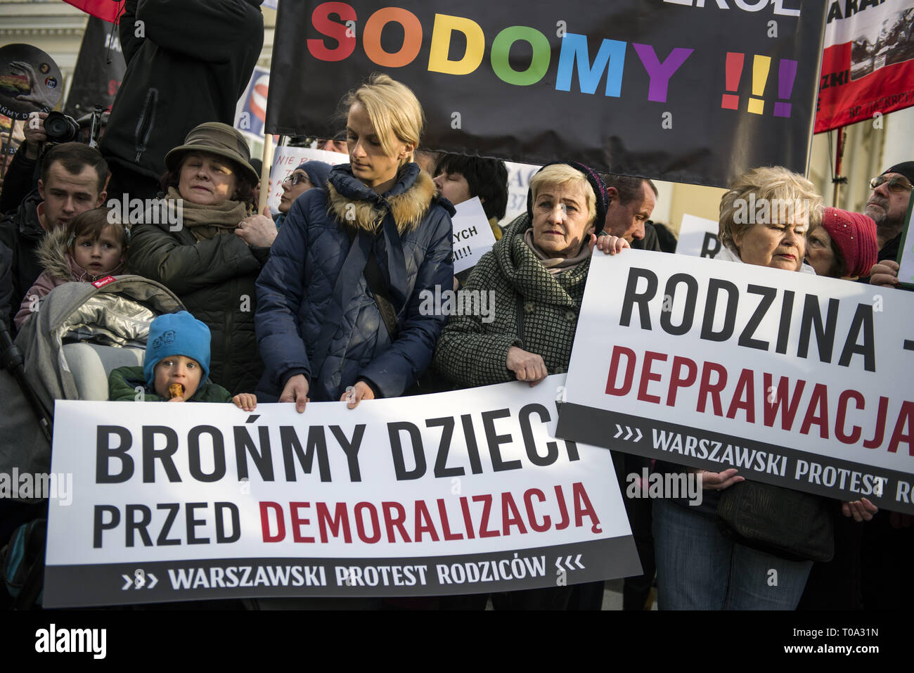 Warsaw, Poland. 18th Mar, 2019. Protesters are seen holding a big placard that says Let's save our children from demoralization during the protest.Today outside the Warsaw's town hall, parents of primary and secondary school pupils protested against the new 12-point LGBT  rights declaration signed by the new Mayor Rafal Trzaskowski. Credit: ZUMA Press, Inc./Alamy Live News Stock Photo