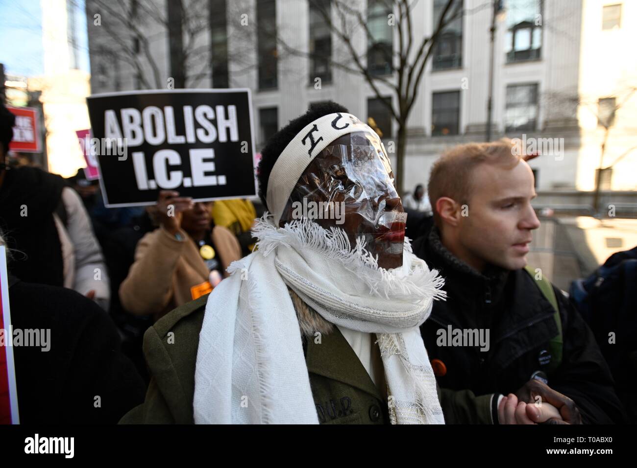 New York, NY, USA. 19th Mar 2019.  Supporters escort Statue of Liberty climber Patricia Okoumou, with clear plastic covering her face, into federal court before her sentencing for her July 4, 2018, act of civil disobedience to protest against Trump administration immigration policies.  Okoumou was convicted in December of misdemeanor charges of trespassing, disorderly conduct, and interfering with the functioning of government. Credit: Joseph Reid/Alamy Live News Stock Photo