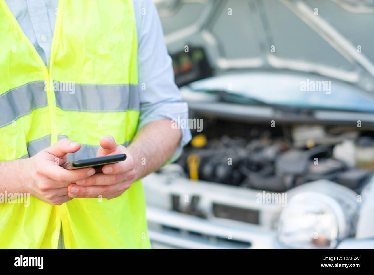 Stressed driver after car breakdown calling roadside service Stock Photo