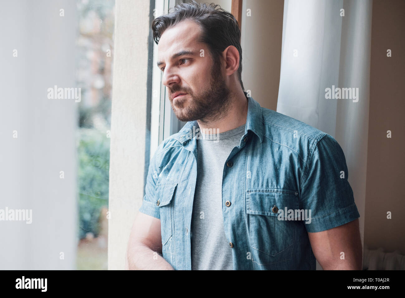 Man suffering and feeling alone at home Stock Photo