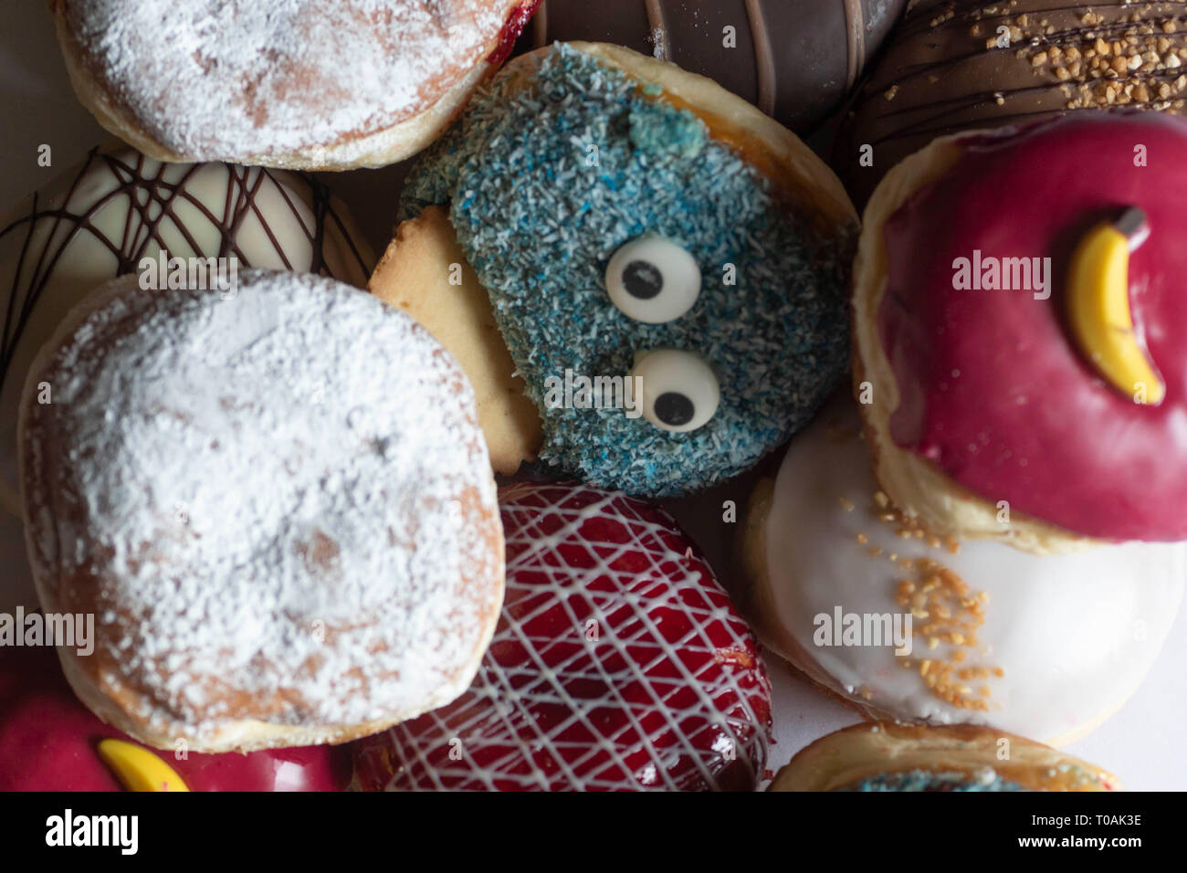 Delicious freshly baked Berliner with various toppings Stock Photo - Alamy