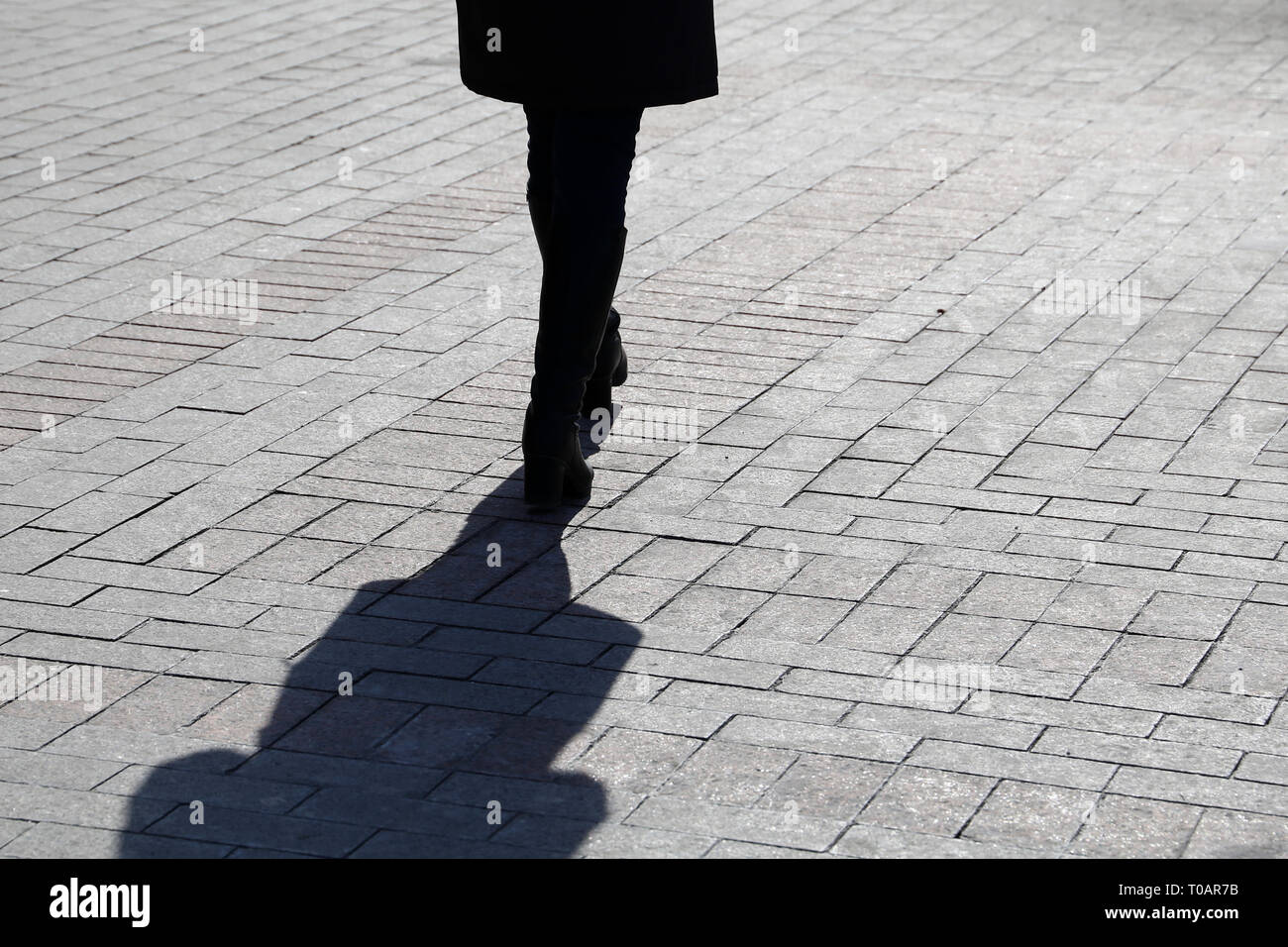 Silhouette of lonely woman walking down the street, black shadow on ...