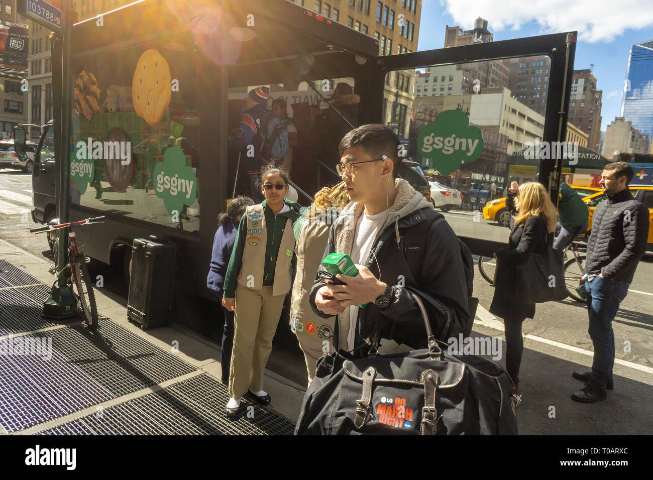 Intrepid Girl Scout cookie lovers brave the winter weather to buy cookies from the Girl Scouts Cookie Truck parked near Pennsylvania Station in New York on Saturday, March 16, 2019. The truck will travel stopping in the five boroughs bringing Thin Mints, S'Mores and other delectable cookies to New Yorkers.  (Â© Richard B. Levine) Stock Photo