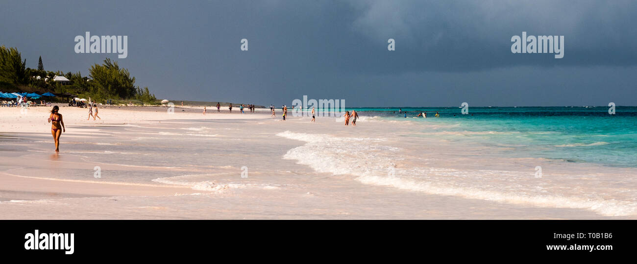 Woman Walking in the Surf, on Pink Sands Beach, Harbour Island, Eleuthera, The Bahamas, The Caribbean. Stock Photo