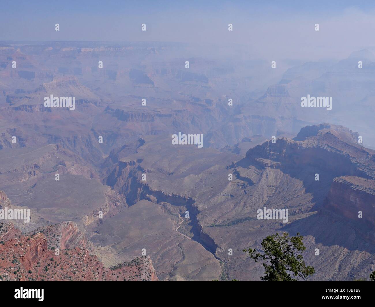 Astounding scenic view of the Grand Canyon south rim in Arizona shrouded with smoke from wildfires. Stock Photo