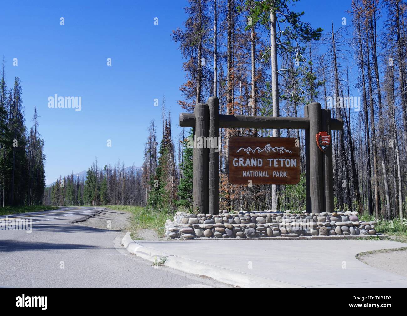 Wide shot of the Grand Teton National Park sign on the boundary of Yellowstone National Park. Stock Photo