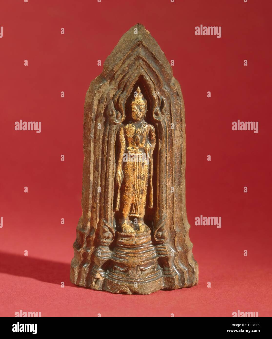 'Votive Plaque with a Representation of Standing Buddha'. Siam (now Thailand).Late Ayutthaya -early Bangkok, 18th - early of the 19th century. Dimensions: 10x5 cm. Museum: State Hermitage, St. Petersburg. Stock Photo