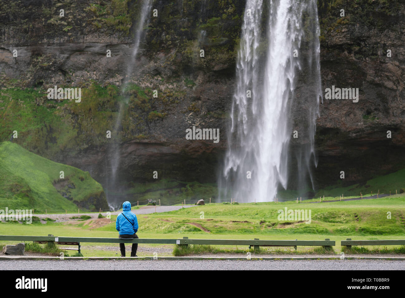 Selyalandfoss waterfall in Iceland. Tourist enjoys the view of the river cascade Stock Photo