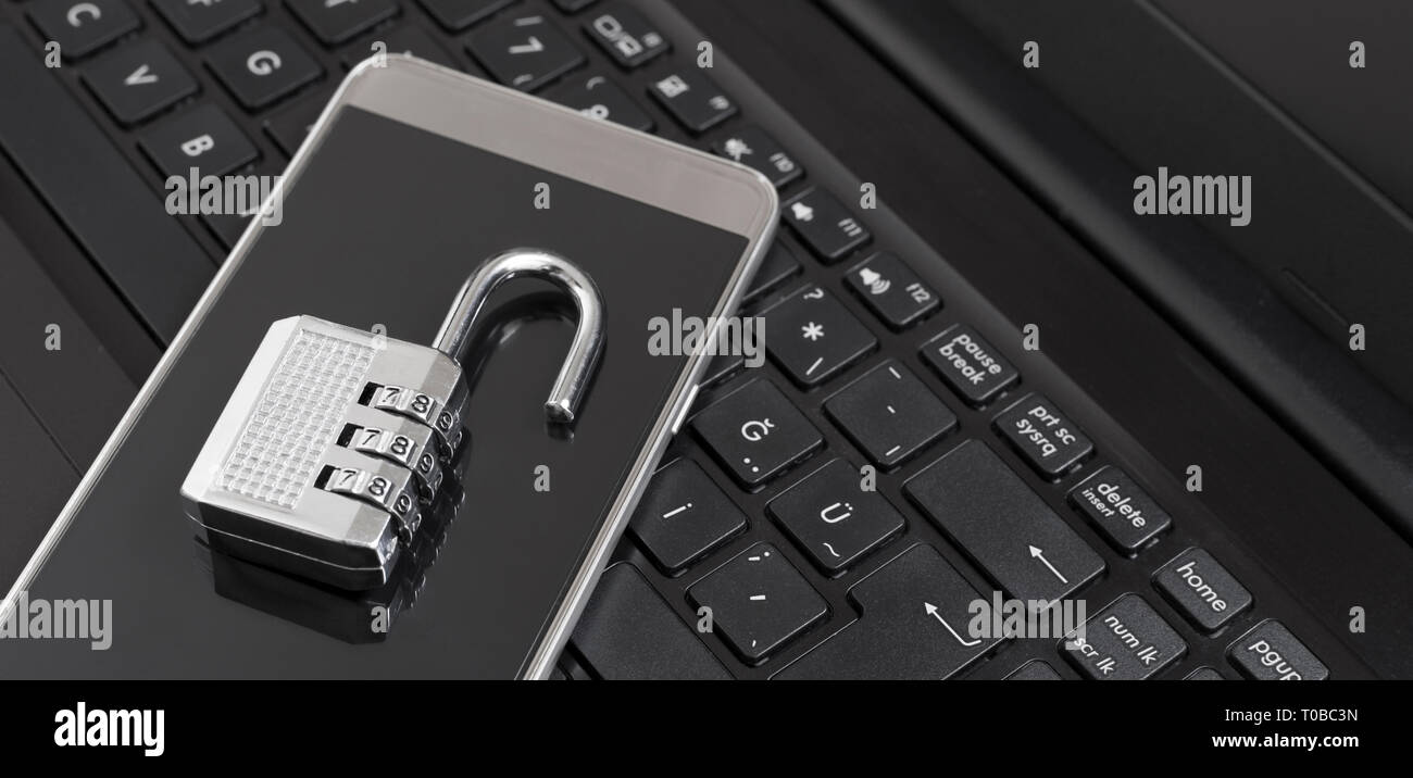 Combination lock on phone and labtop keyboard Stock Photo - Alamy