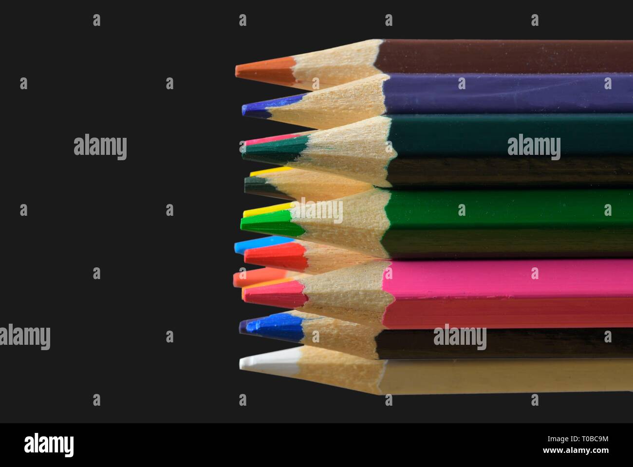 Textured wood colored pencils. Colored pencils macro. Assortment of colored wood drawing pencils