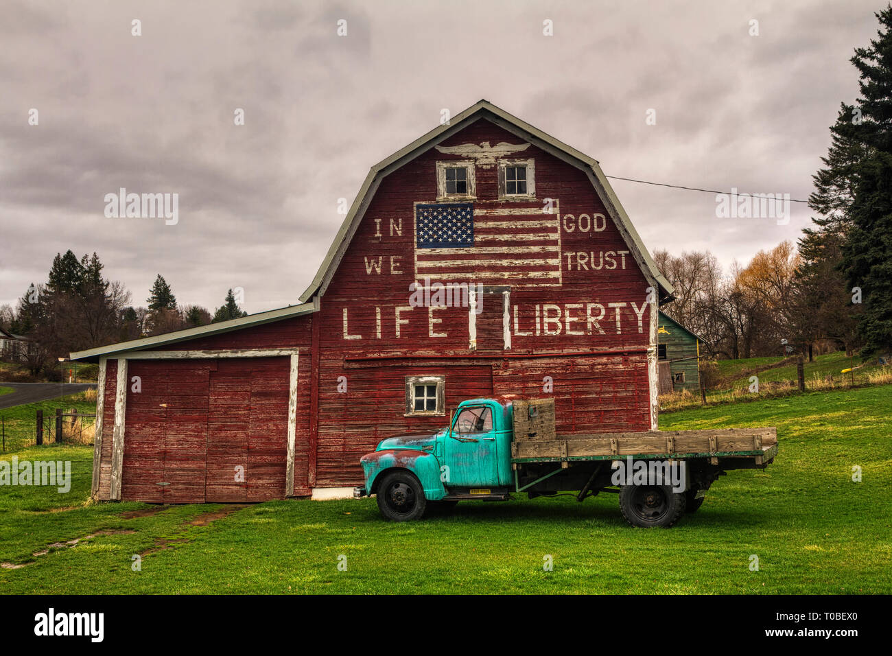 A barn located in a small town of the Palouse Region of Eastern Washington with a USA Flag and patriotic words painted on it. Stock Photo