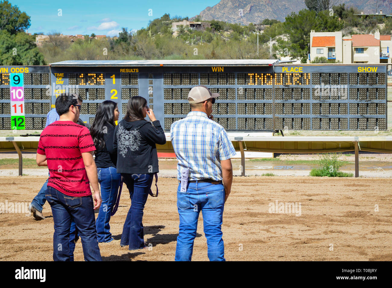 Tote board at the historic Rillito Park race track shows an 'Inquiry' after a horse race, People await the decision by track stewards in Tucson, AZ Stock Photo