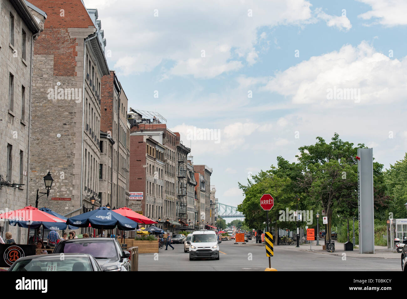 Montreal, Quebec, Canada.  Looking east down Rue de la Commune East near Saint Laurent Boulevard at people and buildings in Old Montreal. Stock Photo