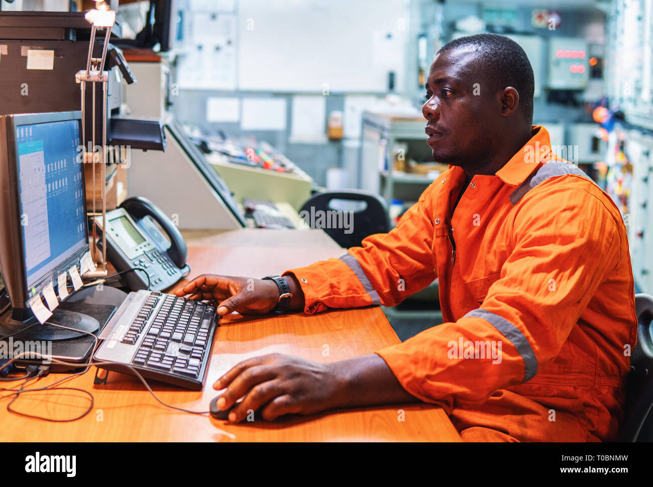Marine engineer officer working in engine room Stock Photo Alamy