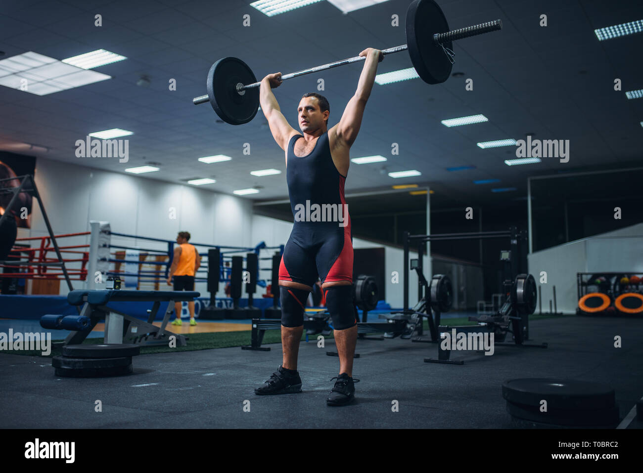 Strong male powerlifter doing deadlift a barbell in gym. Weightlifting