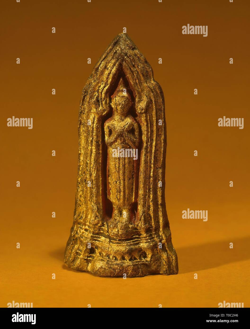 'Votive Plaque with a Representation of Standing Buddha'. Siam (now Thailand).Late Ayutthaya -early Bangkok, 18th - early of the 19th century. Dimensions: 9,5x4,5 cm. Museum: State Hermitage, St. Petersburg. Stock Photo