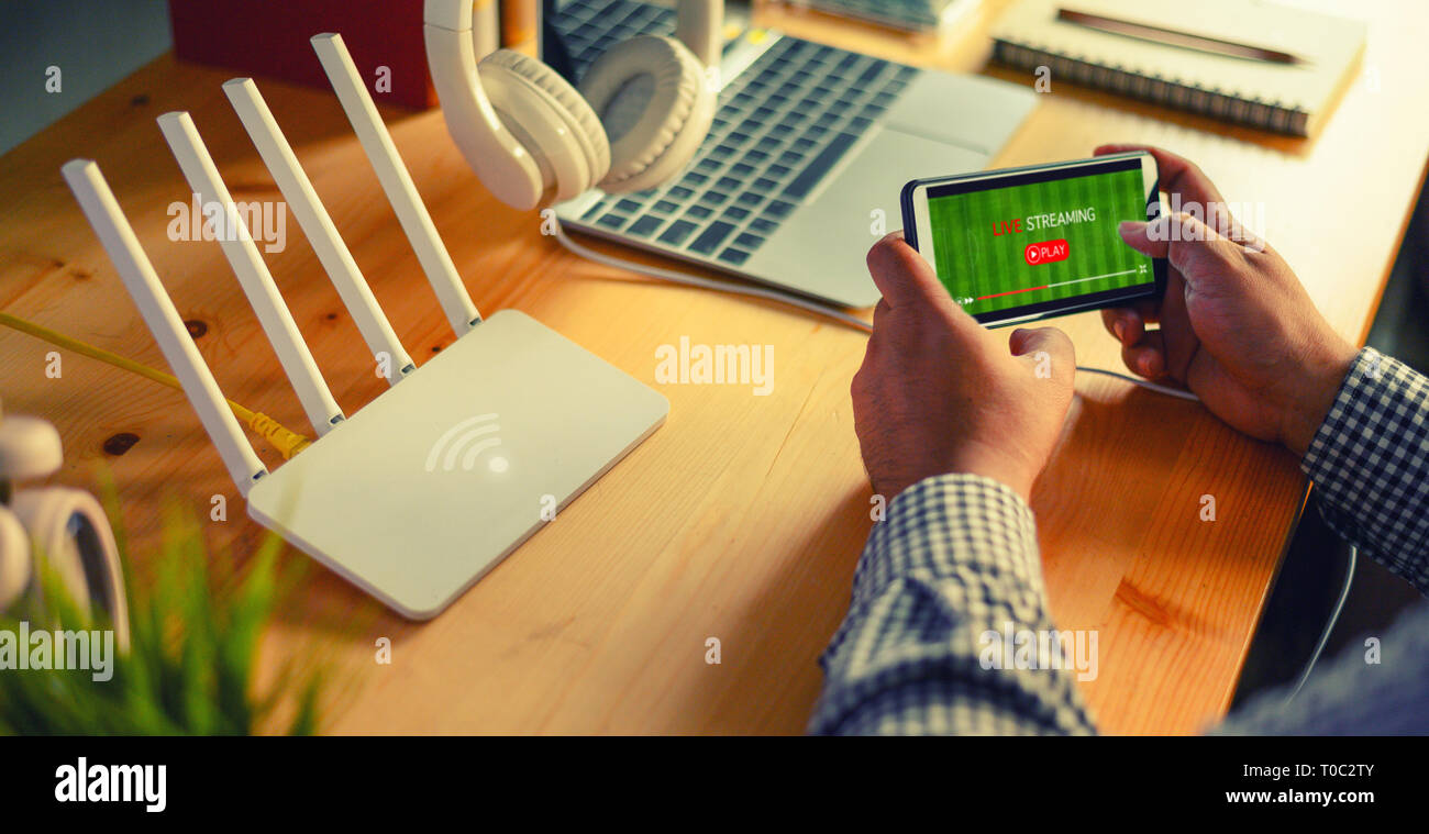 Young man Connecting router wifi On smartphone for Internet and online Live  streaming Stock Photo - Alamy