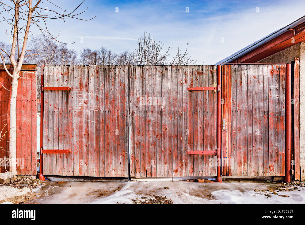 Wooden ancient gate by the house at spring time Stock Photo - Alamy