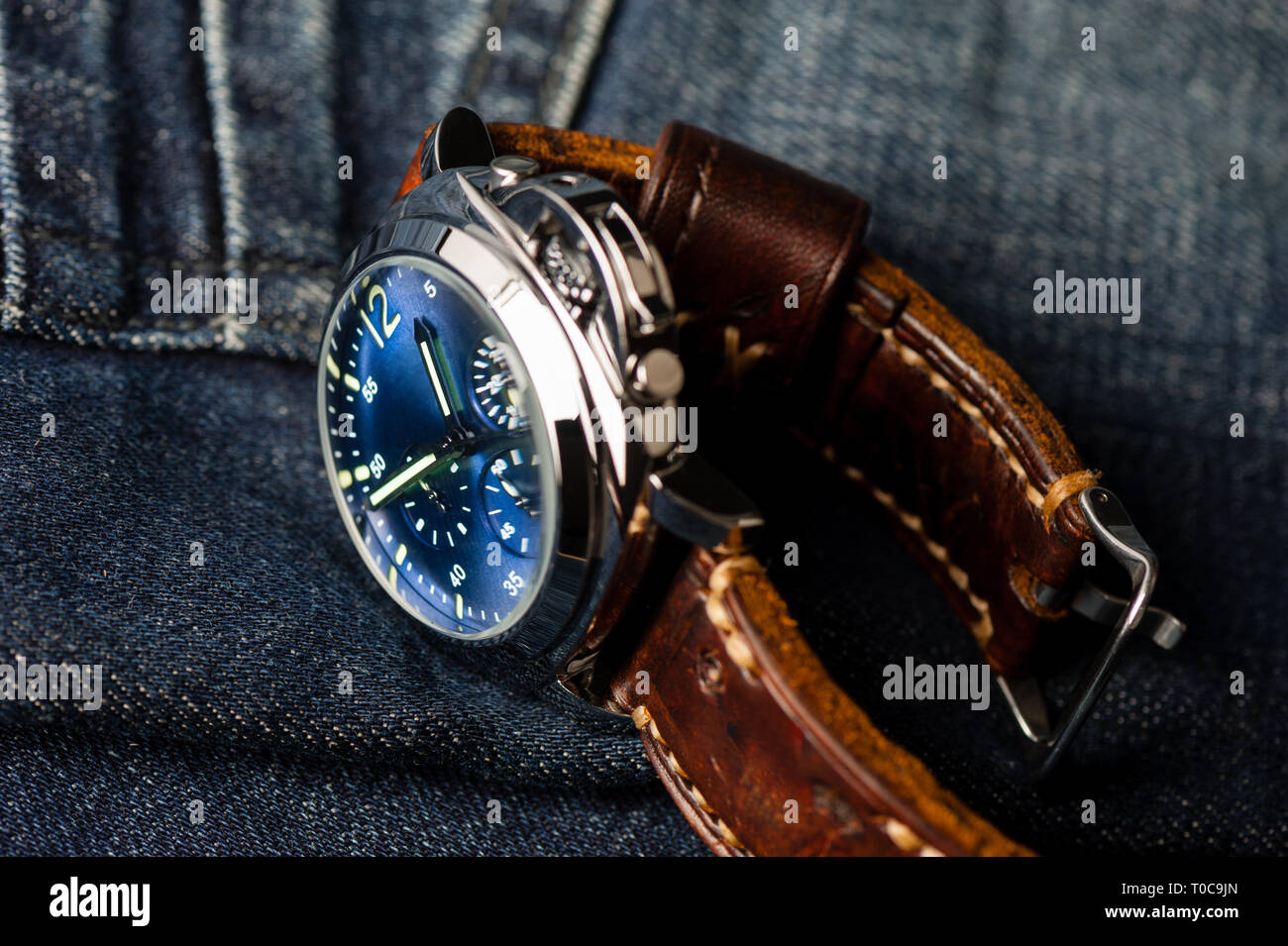 luxury fashion watch with blue dial and brown leather watch band (ammo  style watch strap Stock Photo - Alamy
