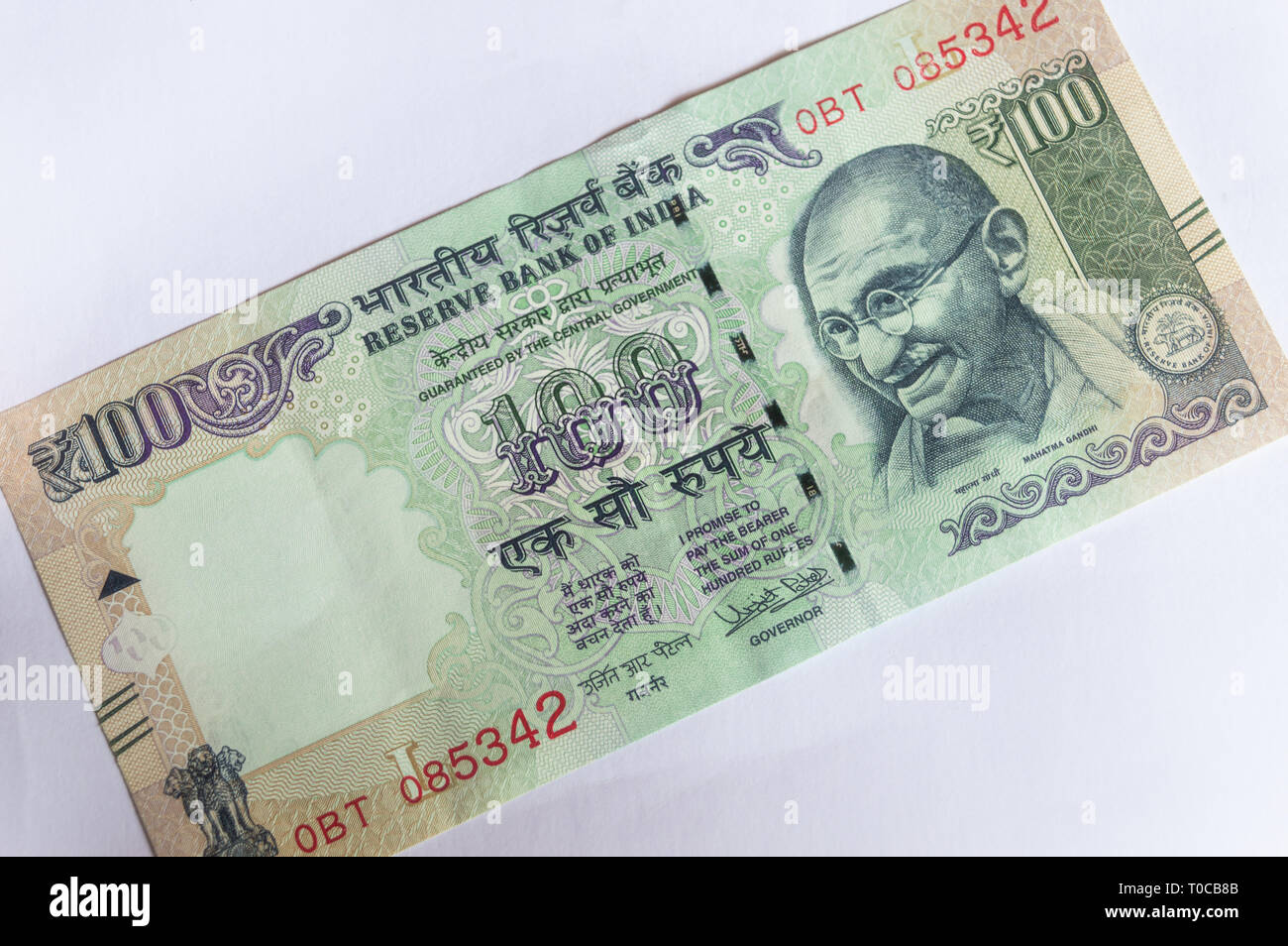 Indian currency 100 Rs note placed diagonally on a white background Stock Photo