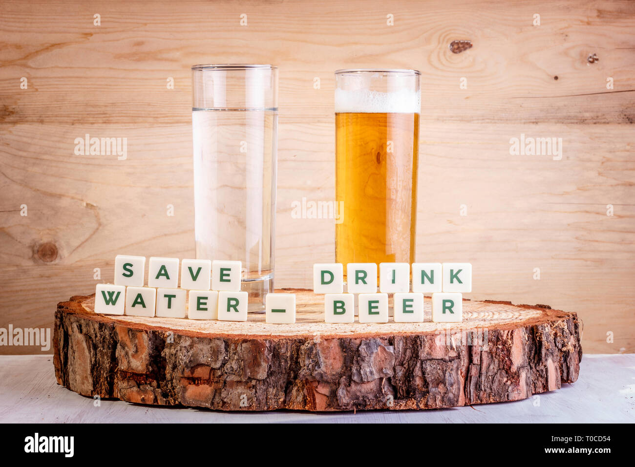Save water, drink beer - glass of water with glass of beer. Ecology concept Stock Photo