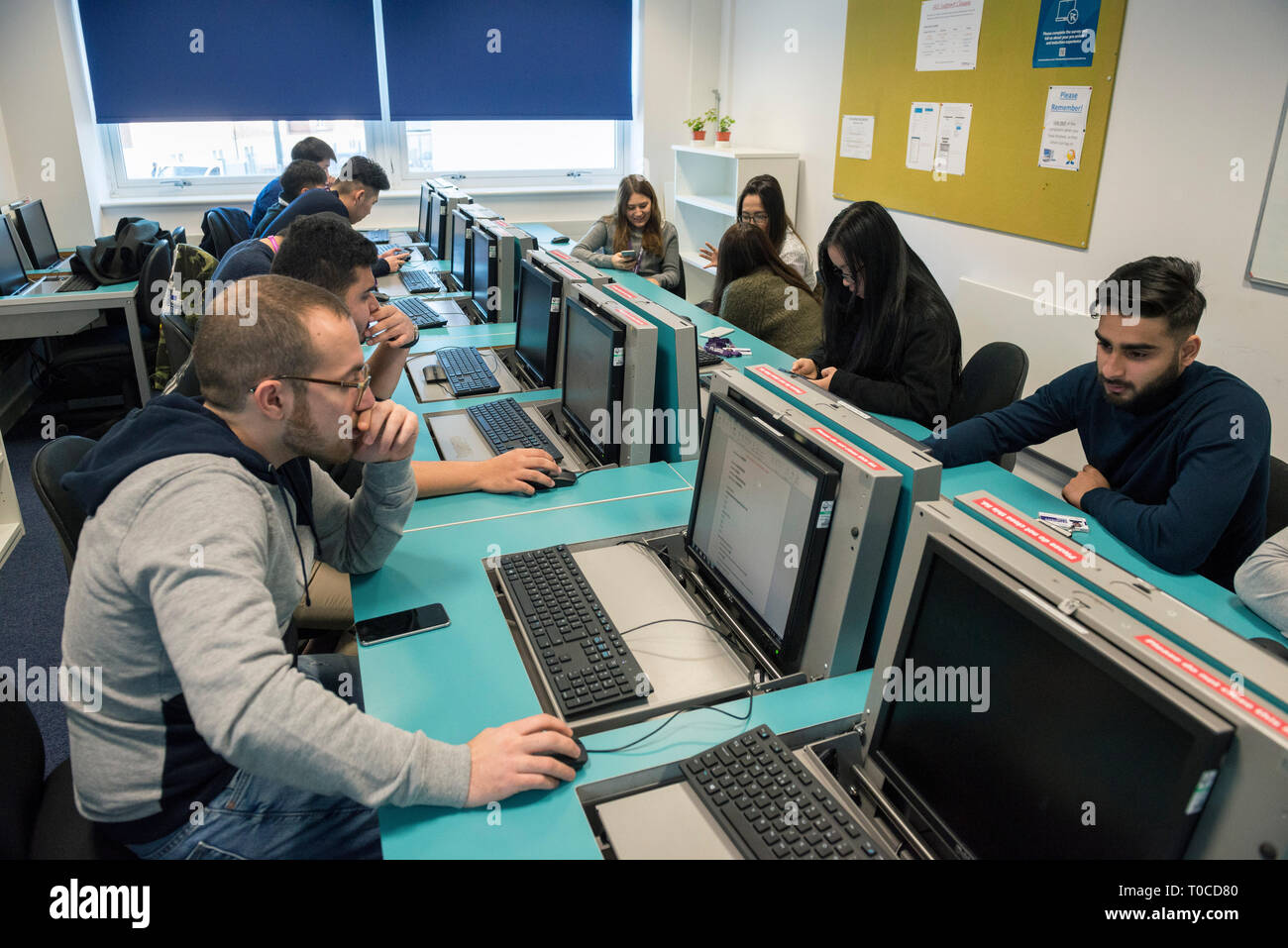 international students and pupils in the computer room of a college