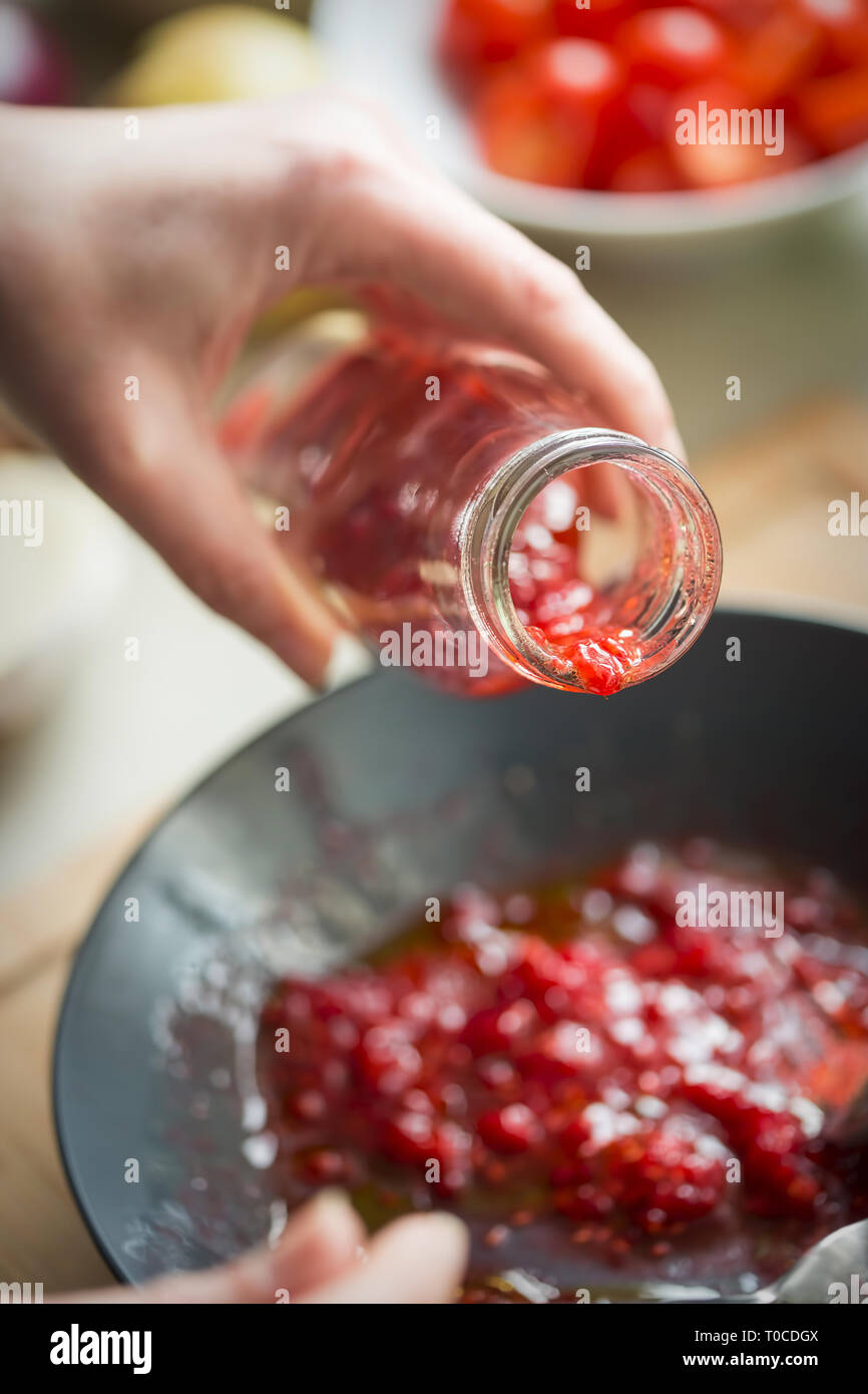 Preparing raspberry vinaigrette dressing Stock Photo