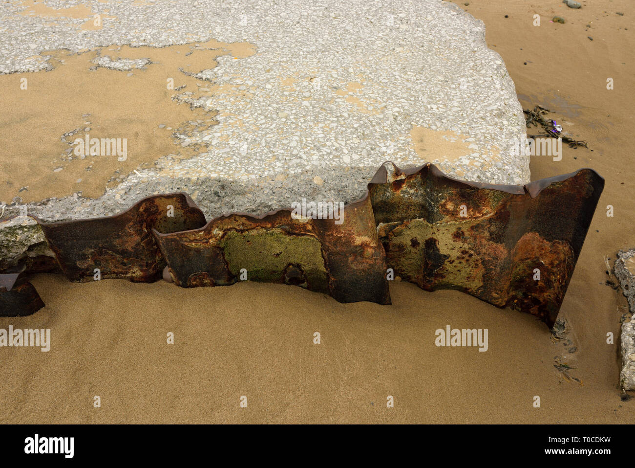 Damaged concrete sea wall and steel sheet piling on sandy beach at low tide at anchorsholme in blackpool, fylde coast in lancashire uk Stock Photo