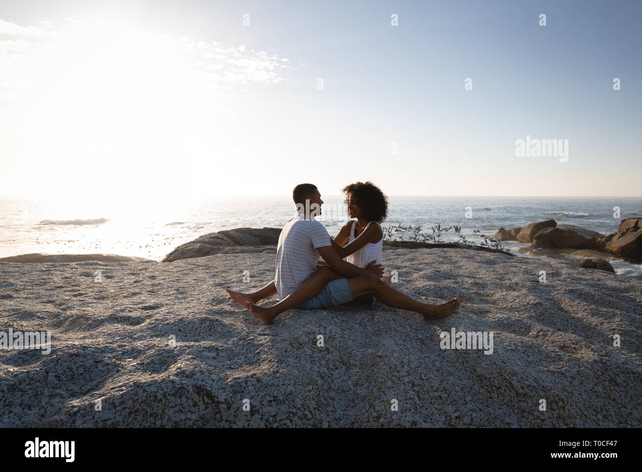 Male and female sitting on rock hi-res stock photography and images - Alamy