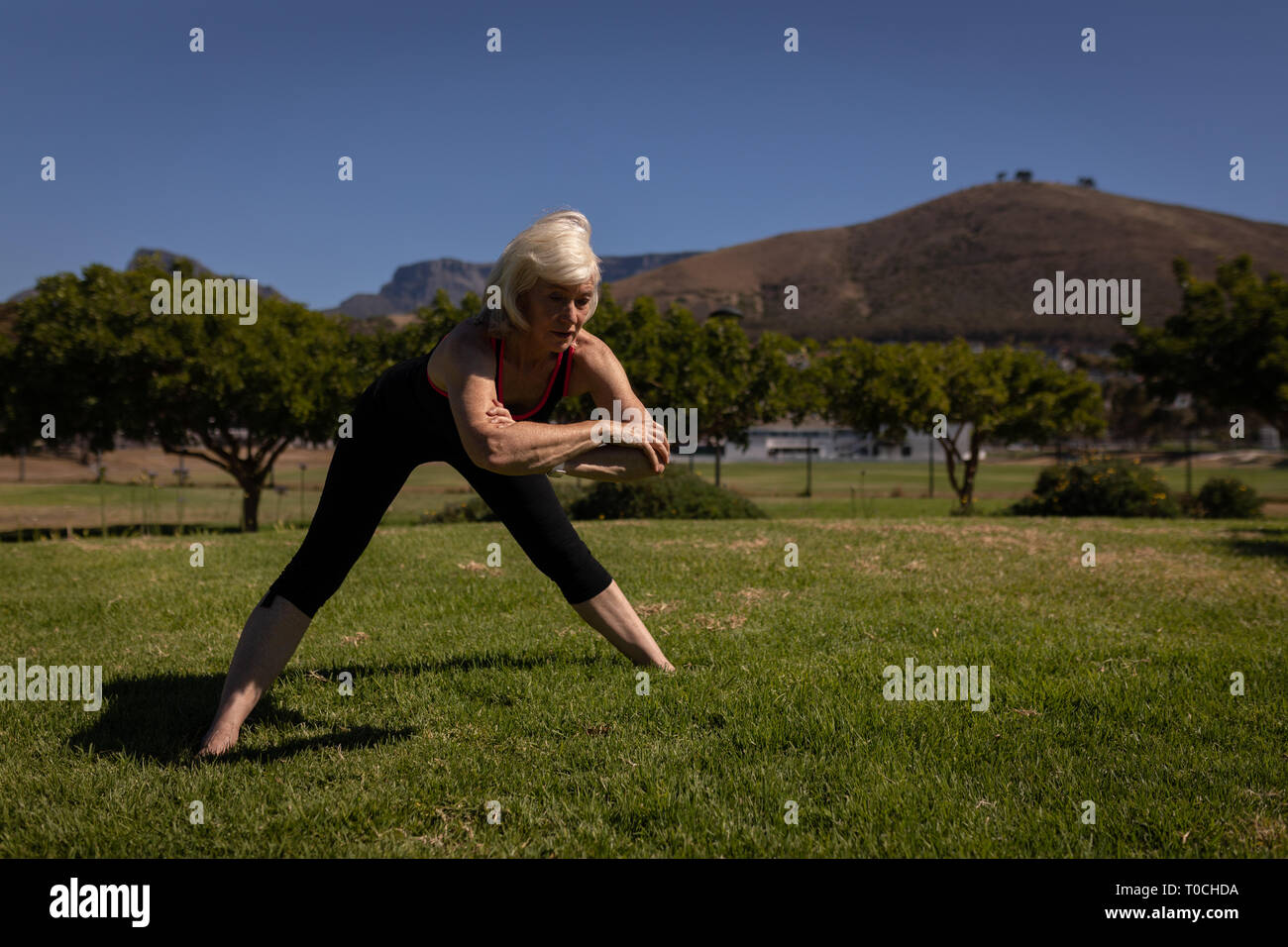 Active senior woman exercising in the park Stock Photo