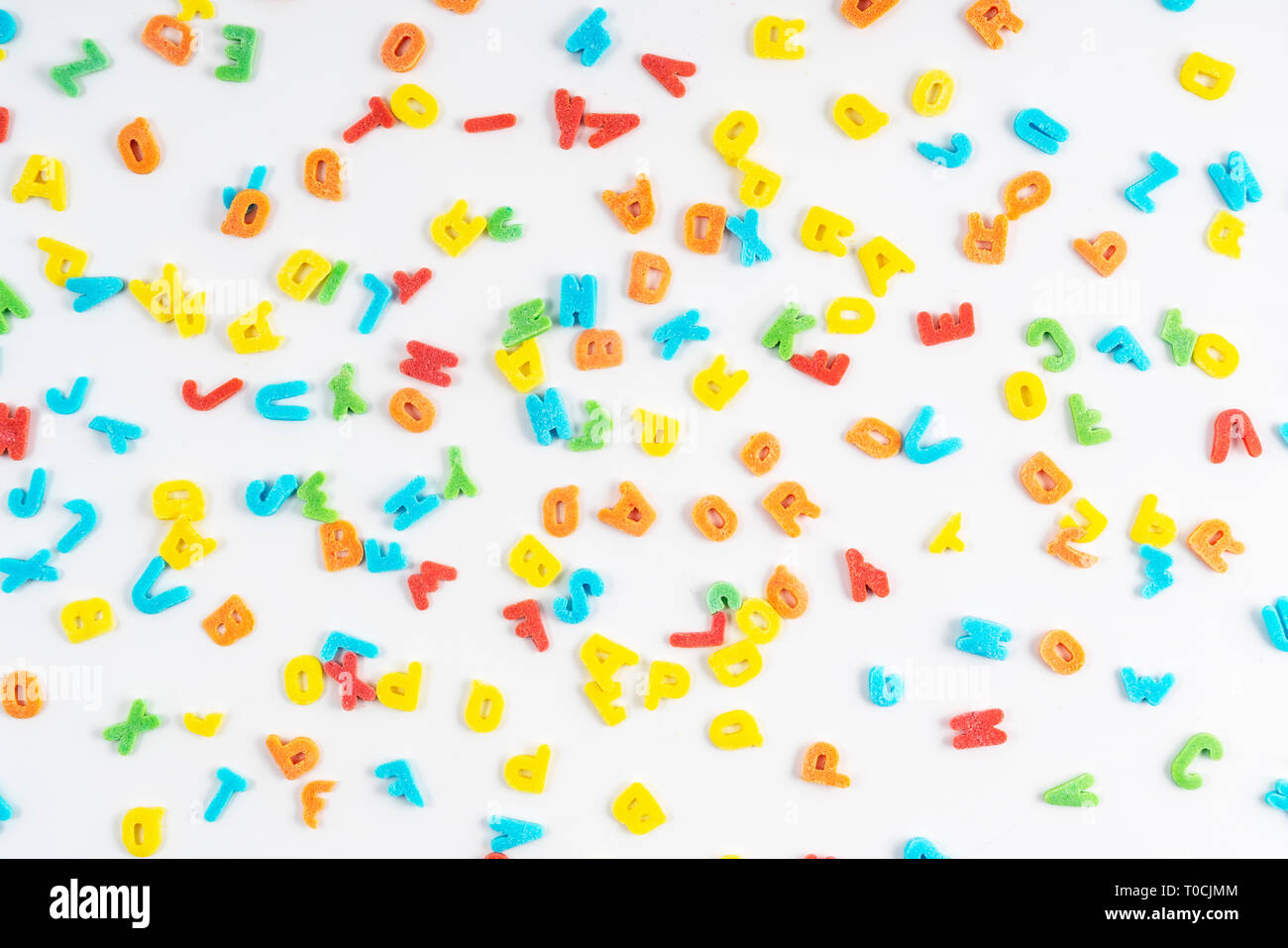 the colorful letters scattered on a white surface Stock Photo