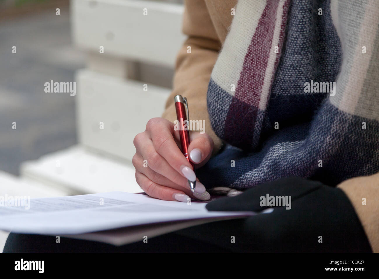 An image of a hand and pen completing a form. Woman hands with pastel ...