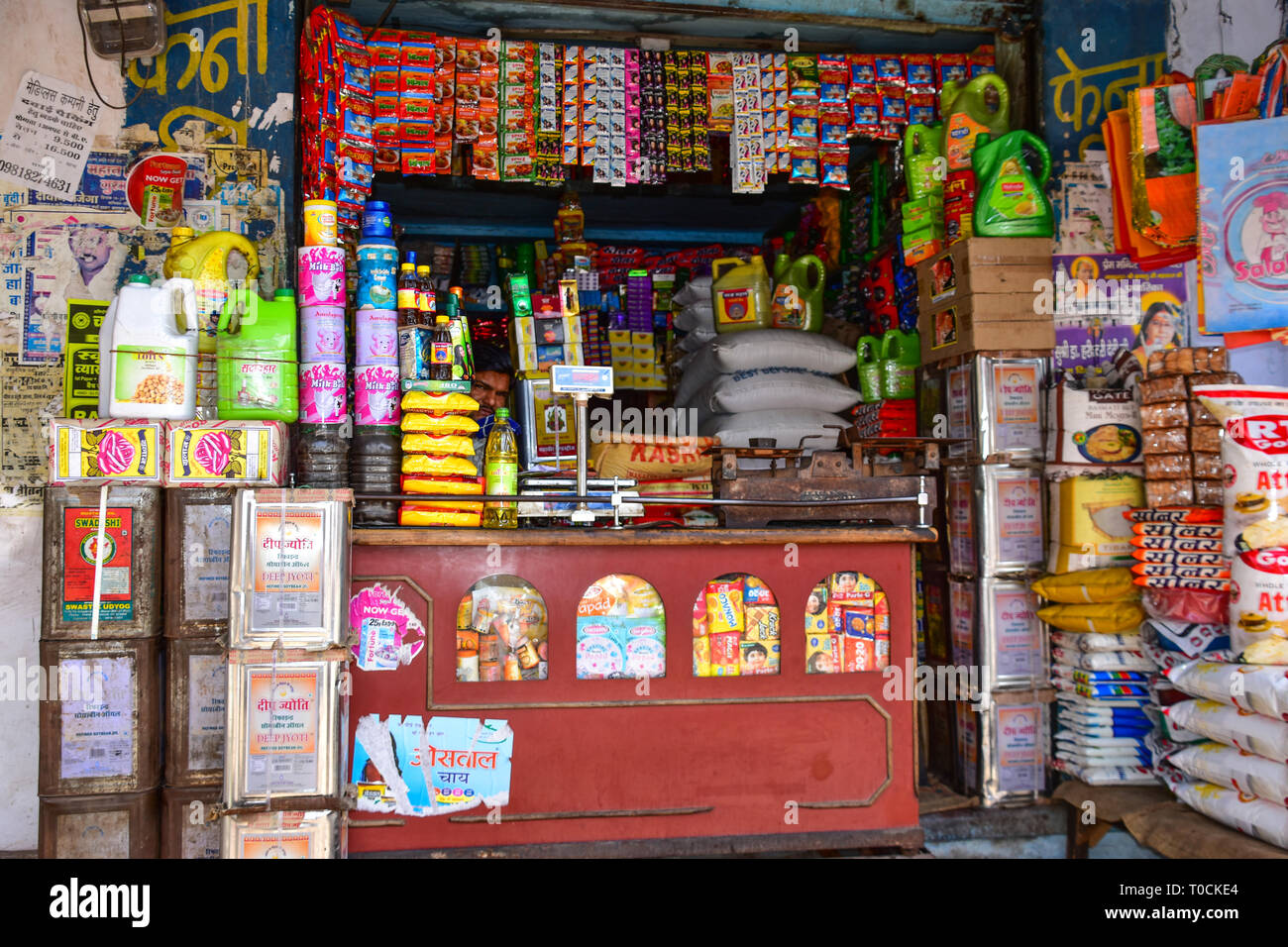 Indian peering out from counter at general store, Bundi, Rajasthan, India Stock Photo