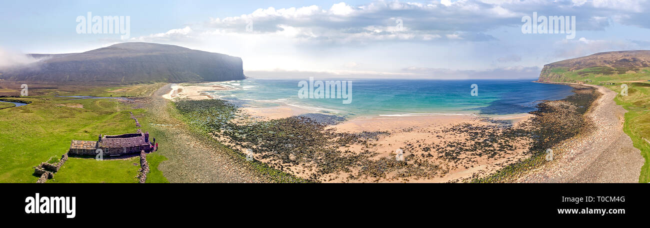 Stunning Drone shots of the rugged shoreline and beaches of the northern islands of Scotland. A clear sunny day shows the cliffs and sandy beaches. Stock Photo