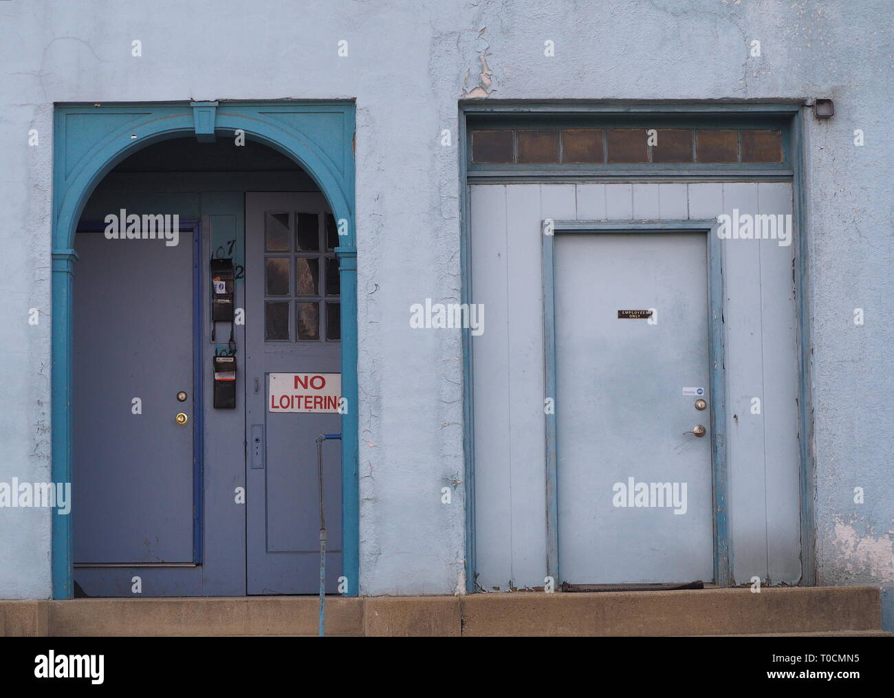 No loitering sign on door blue and slate wall Stock Photo