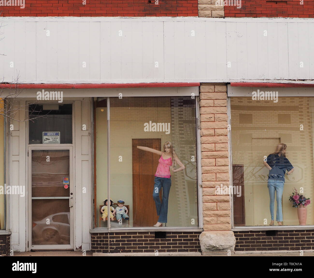 old store front of abandoned clothing store with mannequin Stock Photo