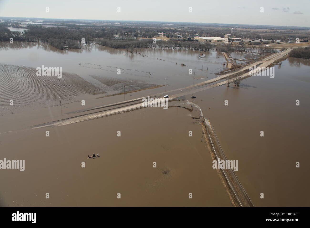 A section of road is underwater stranding a vehicle near Waterloo, Nebraska, after the majority of the local levees were overtopped by floodwaters. Stock Photo