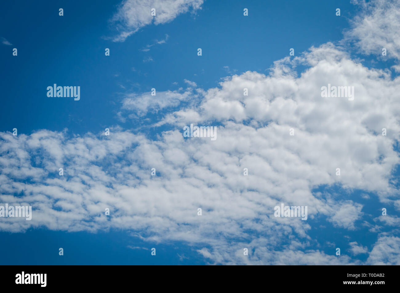 A deep blue sky with continuous white clouds Stock Photo