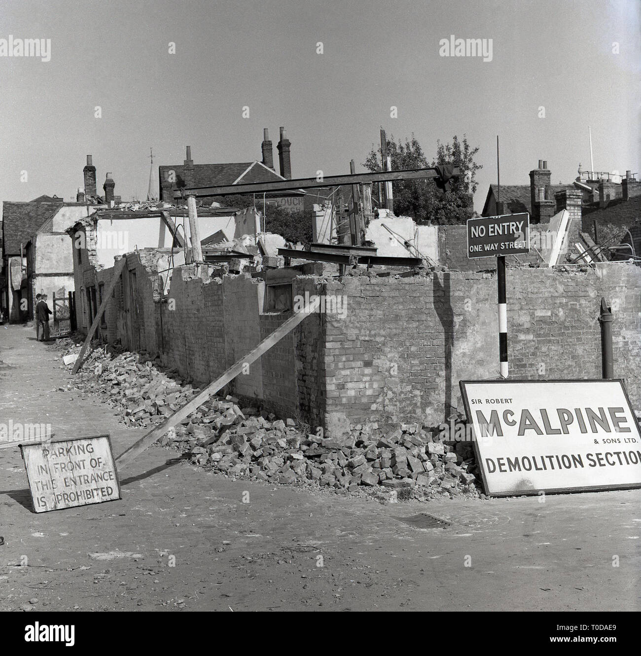 1964, Silver Street, Aylesbury, old buildings in an ancient steet in the centre of the county town being demolished following a fire. Stock Photo