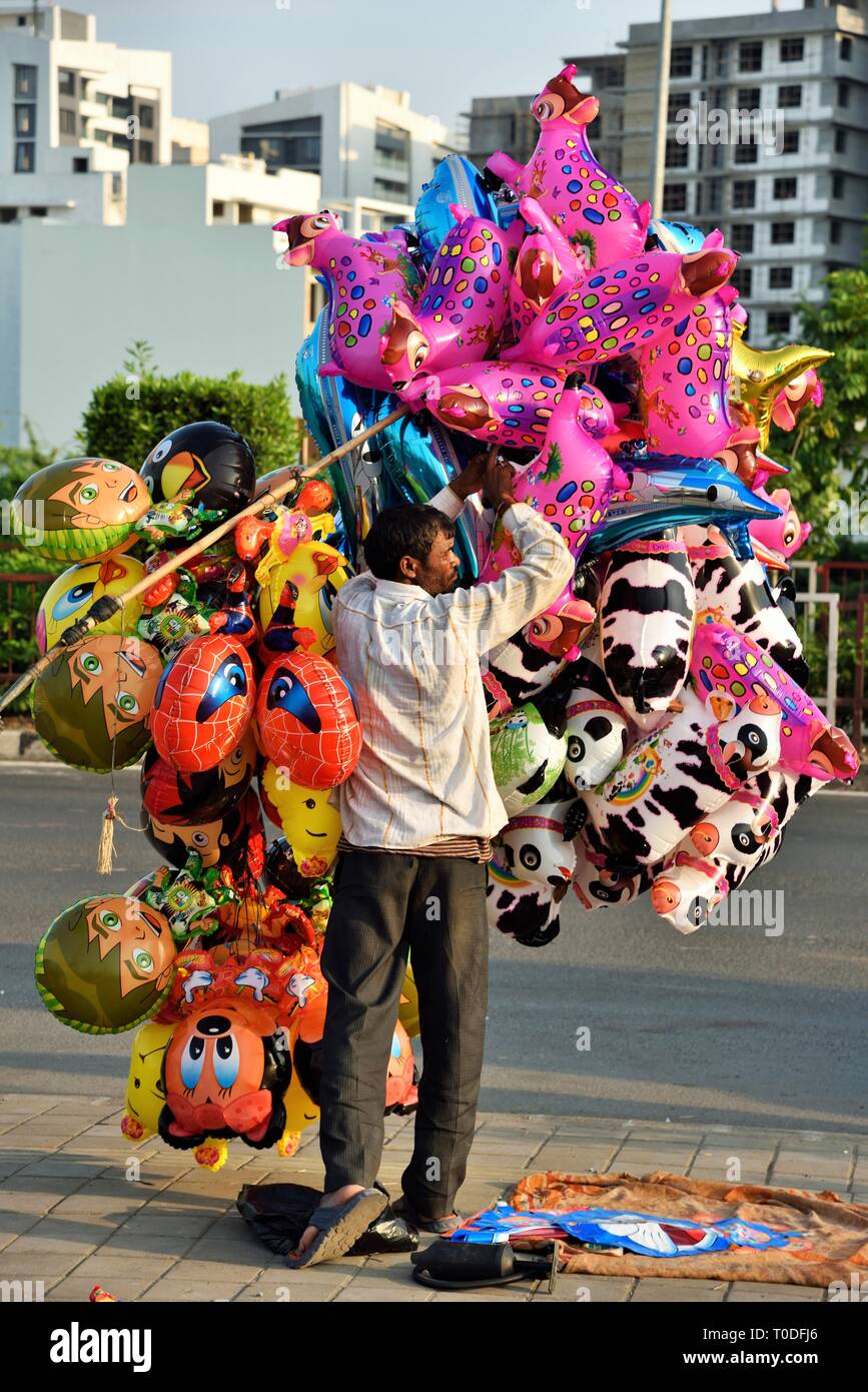 Inflated plastic toys vendor, Surat, Gujarat, India, Asia Stock Photo