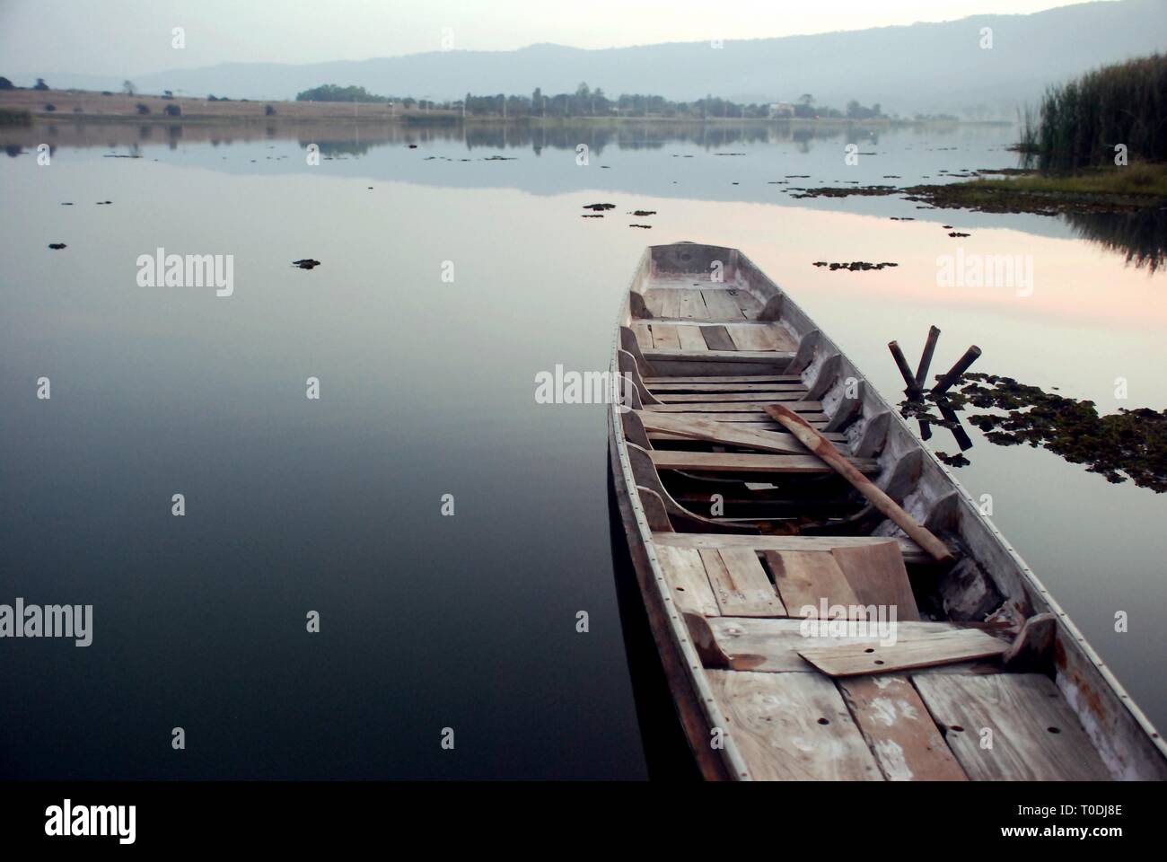 The wooden boat was resting in the river calmly Stock Photo - Alamy