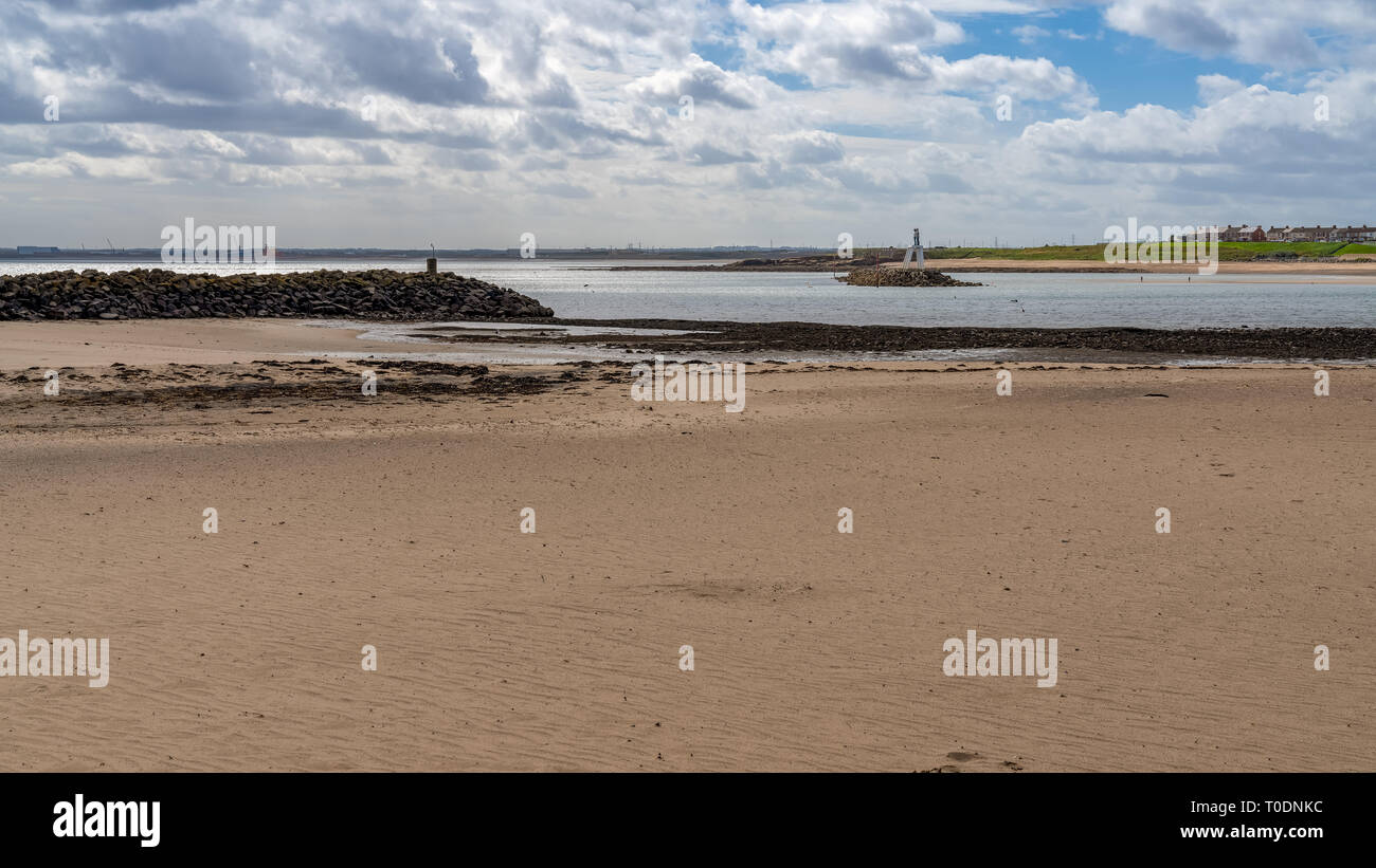 Newbiggin-by-the-Sea, Northumberland, England, UK - September 11, 2018: View at the beach with The Couple (statue) and breakwater Stock Photo