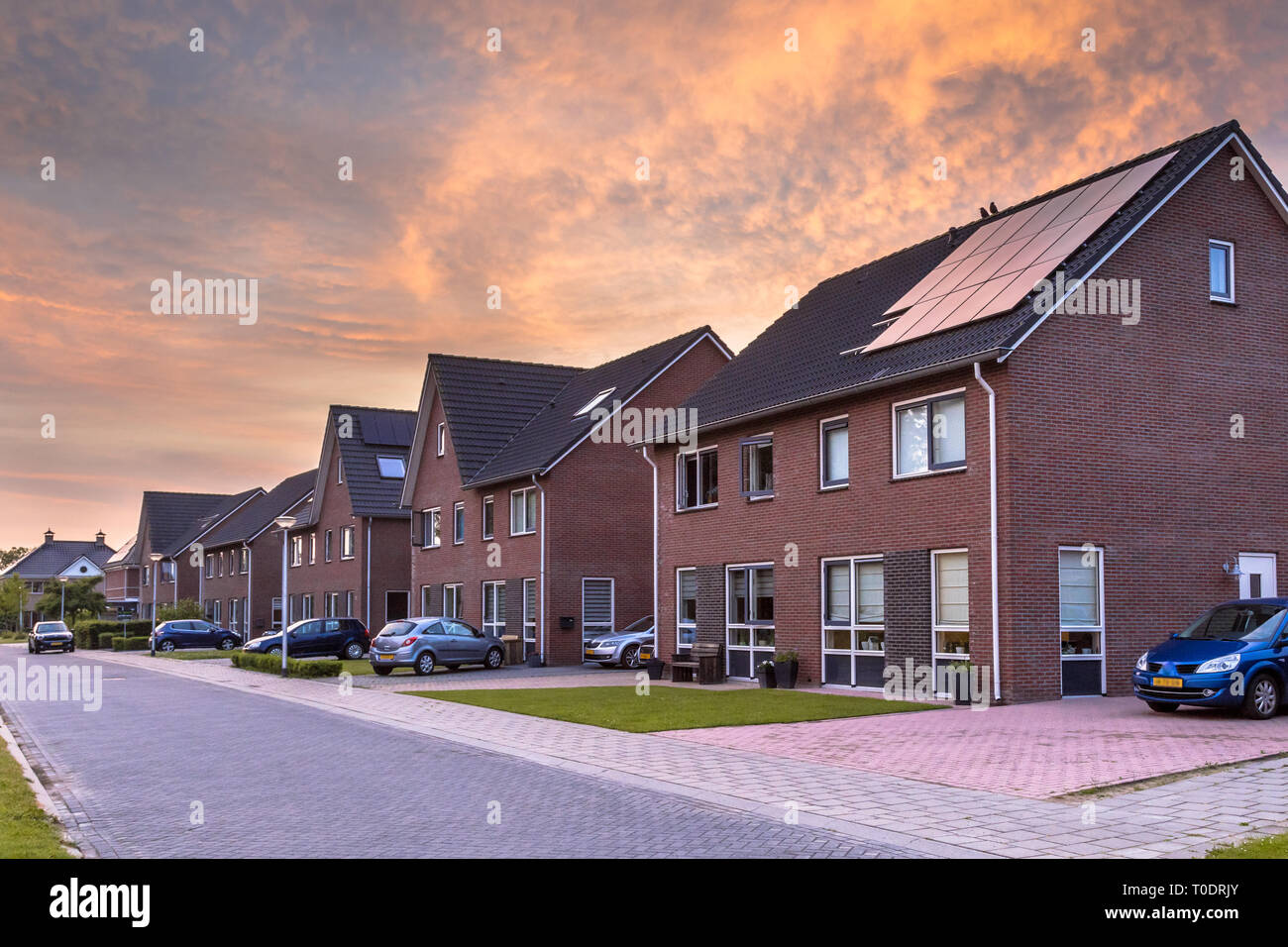 Street with modern family houses in urban suburb in the Netherlands Stock Photo