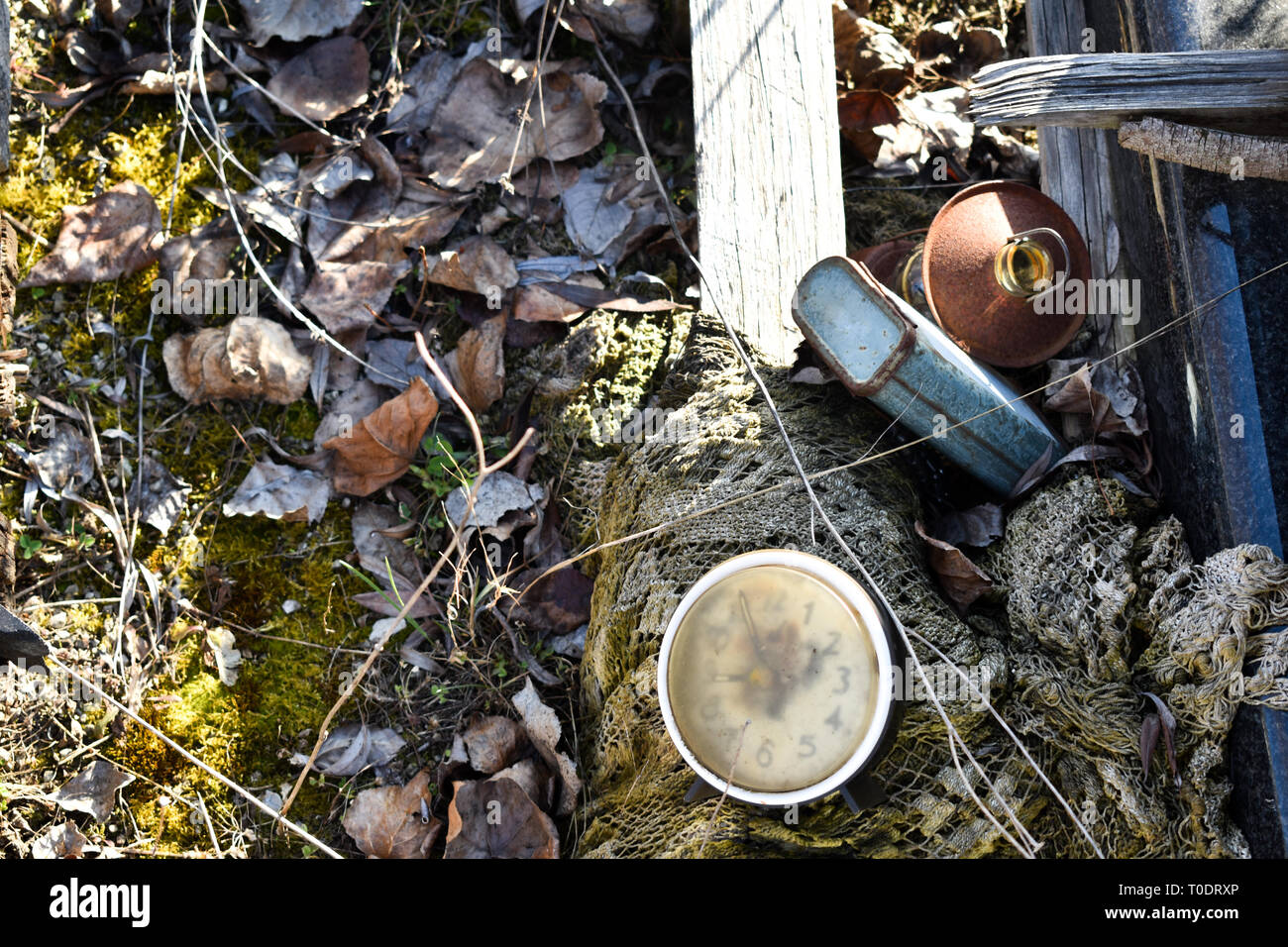 Used junk, waste laying on the ground, net, container, lamp, clock Stock Photo