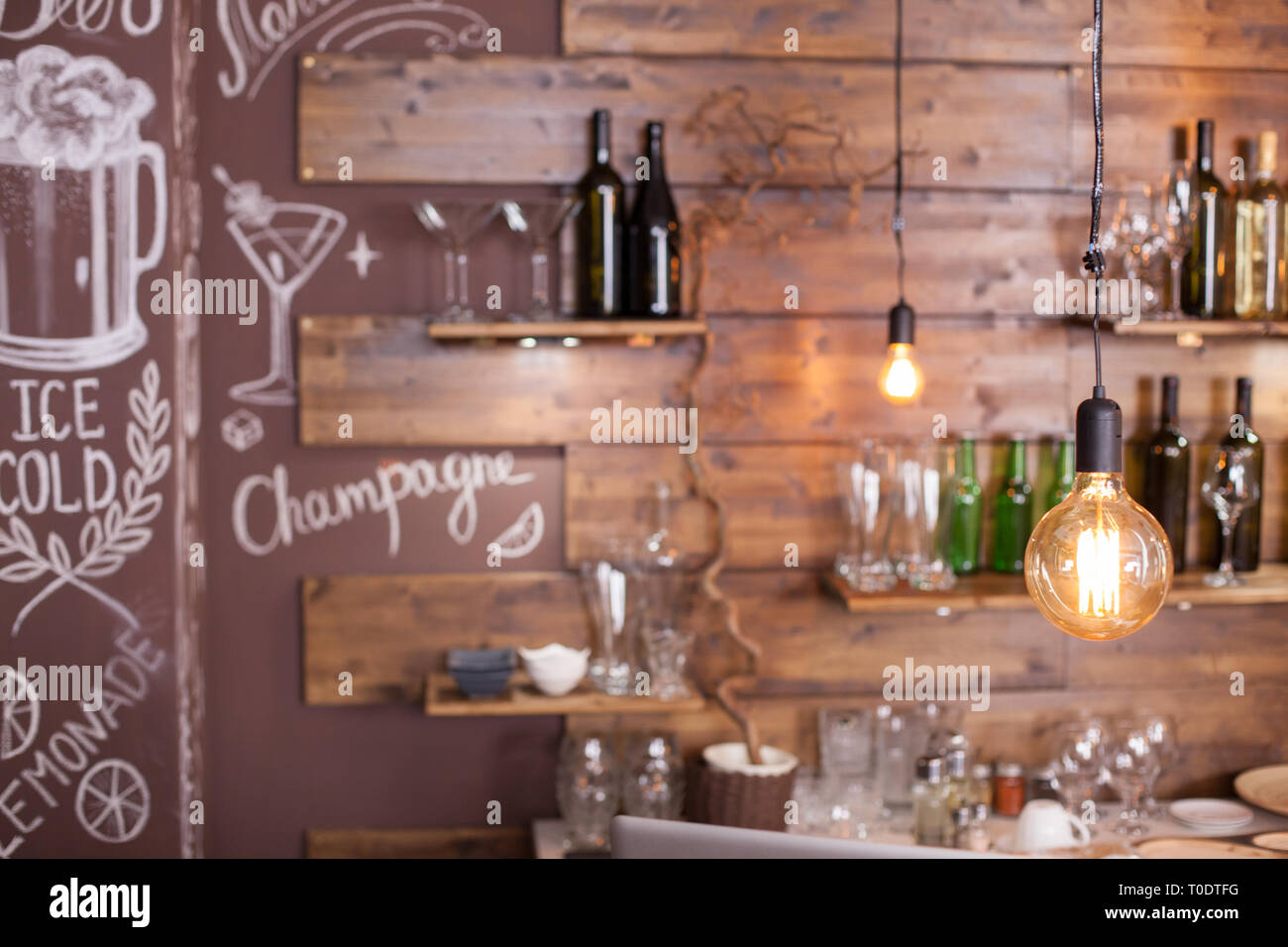 Vintage Light Bulbs Hanging Out Of The Ceiling In A Hipster Coffee