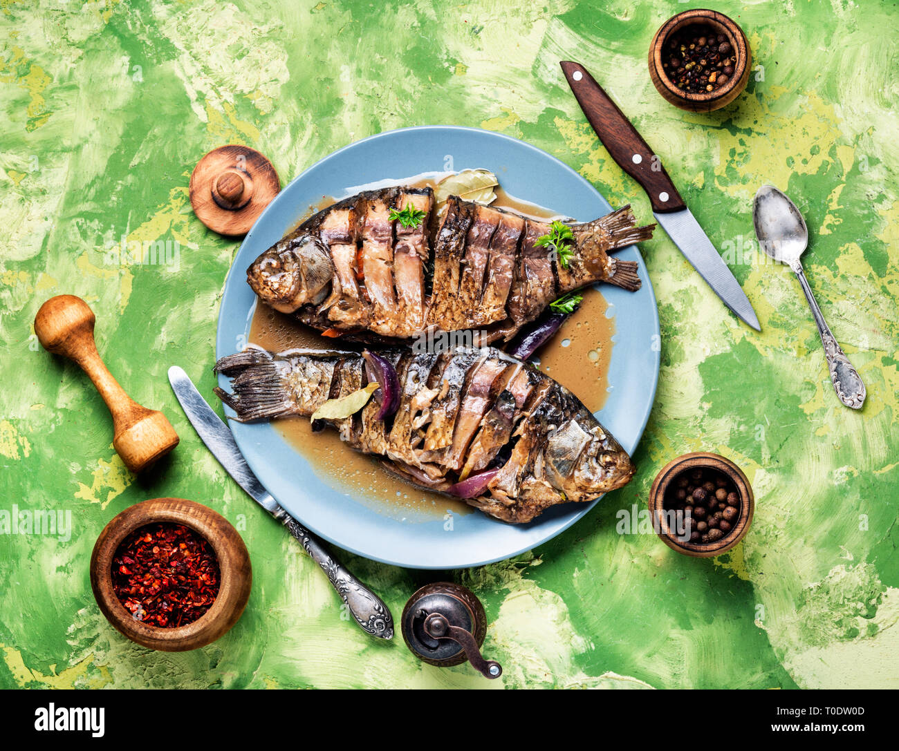 Grilled whole fish with citrus, and vegetable on rustic table Stock ...