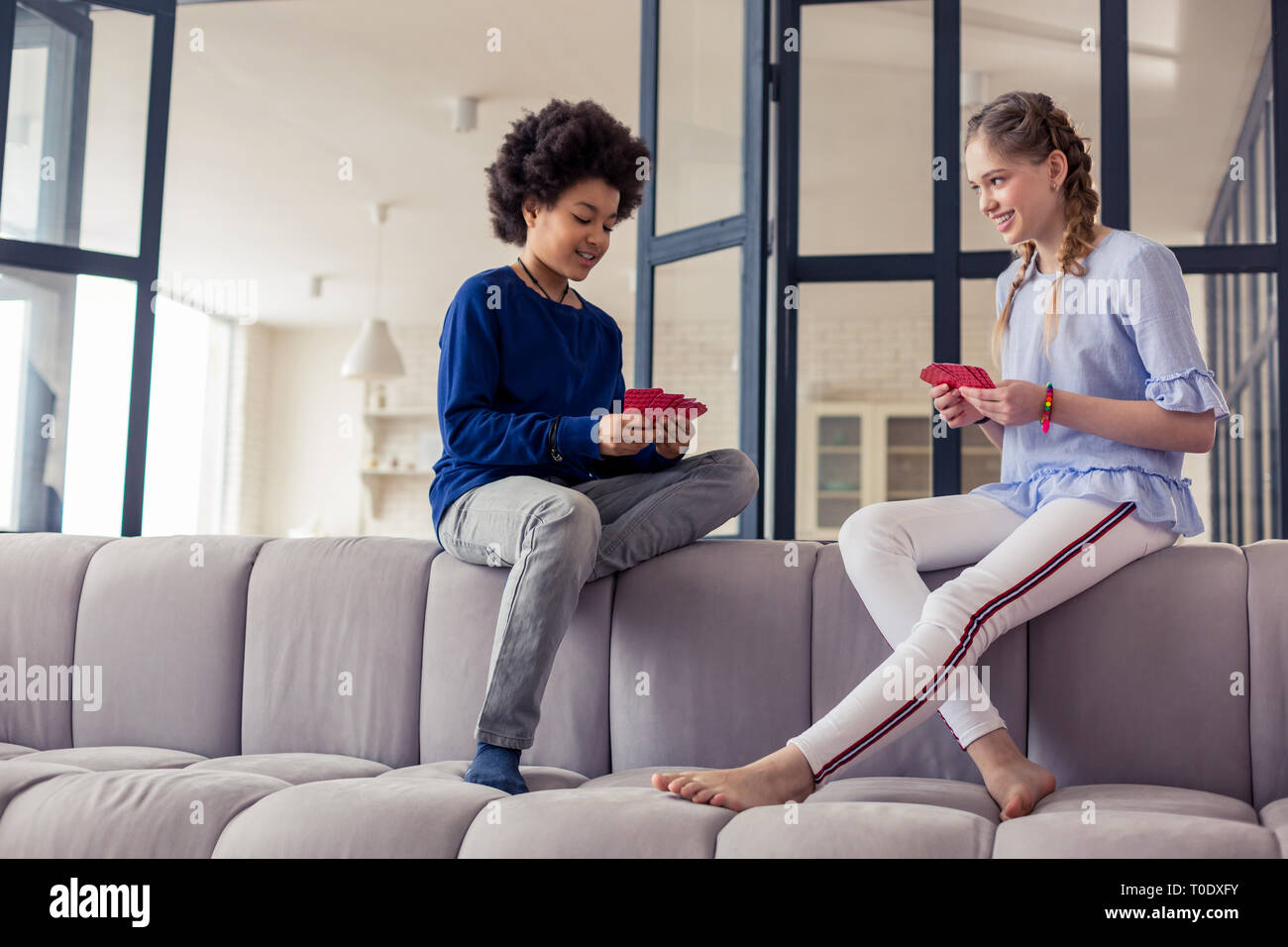Positive delighted children spending free time while playing Stock Photo