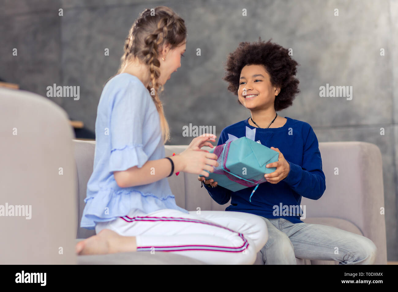 Positive delighted children looking at each other Stock Photo - Alamy